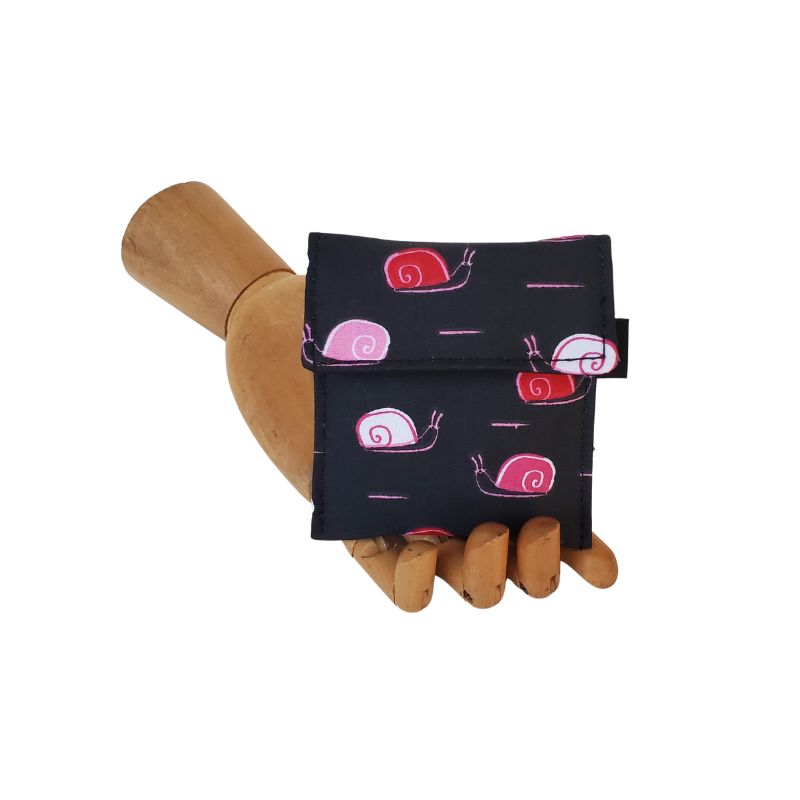 Pink and Red snails partying on a black background. Velcro Mini Wallet by Anne Marie Beard. Handmade in Austin, Texas since 2004 y'all! annemarie mini wallet austin texas snail snails cute creatures