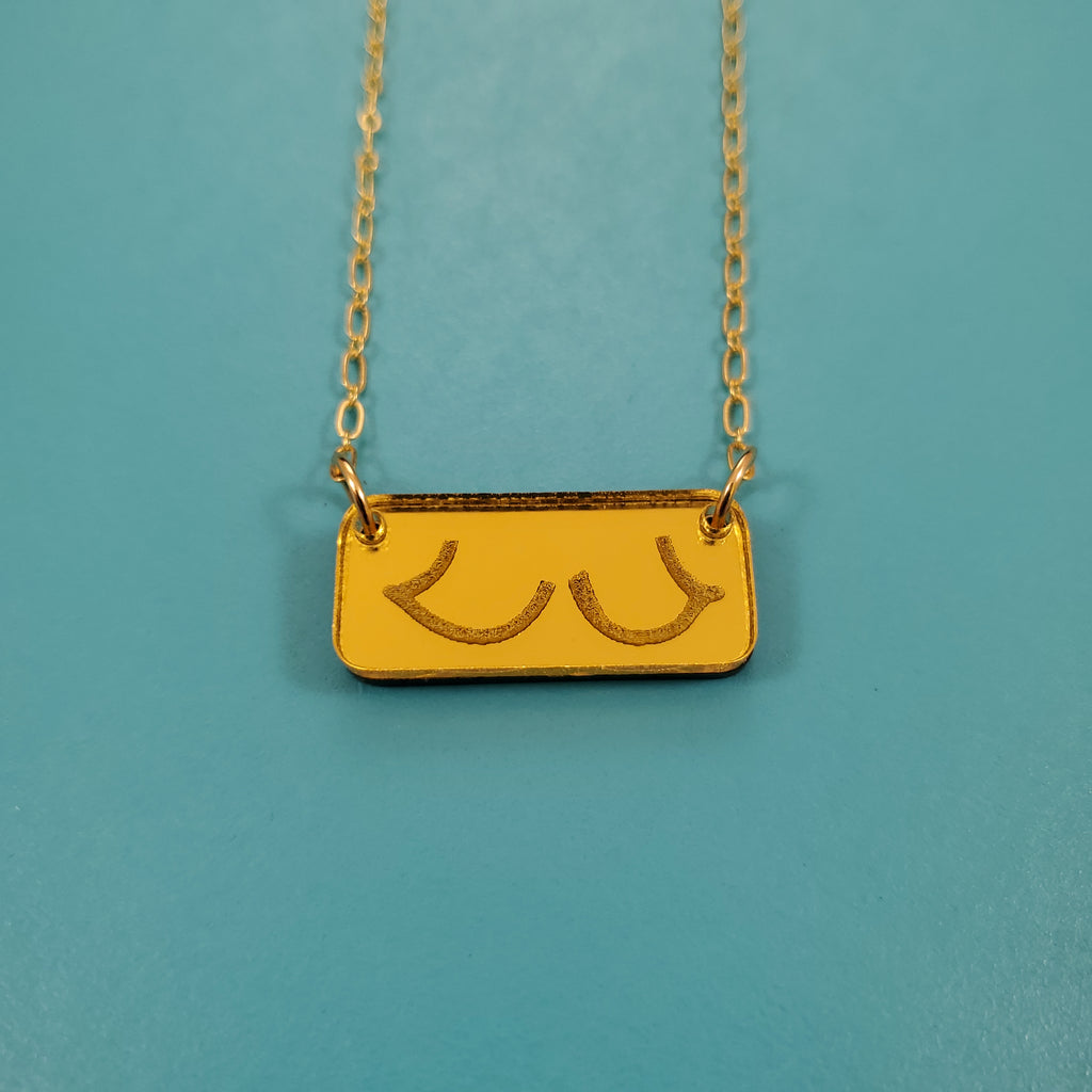 Boobie Bar necklace the torpedo titties in gold close up